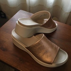 Woman’s full grain leather Ecco slides.